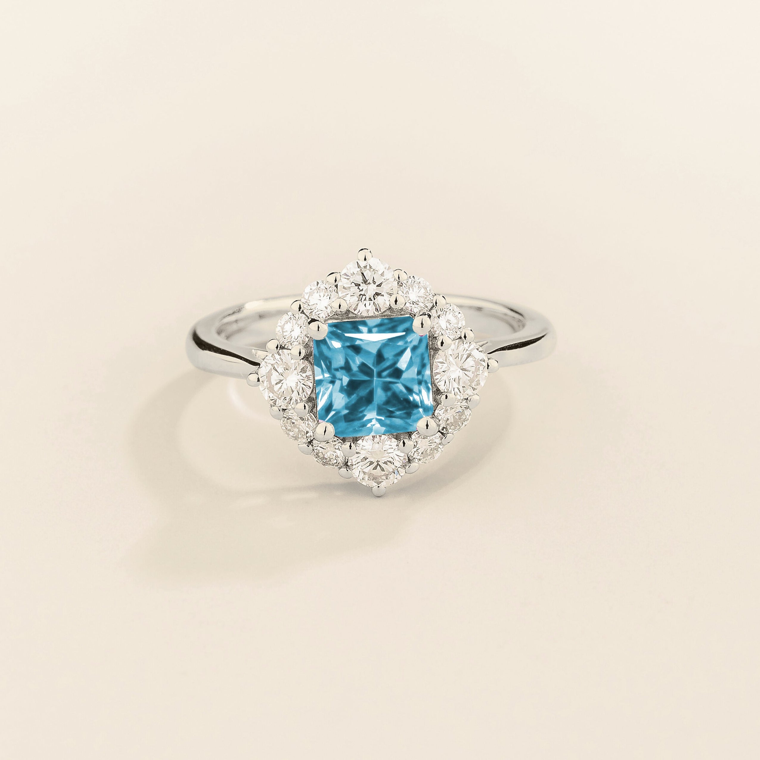 Juvetti white gold ring featuring an octagon-cut lab-grown aquamarine surrounded by round brilliant lab-grown diamonds in a halo design.