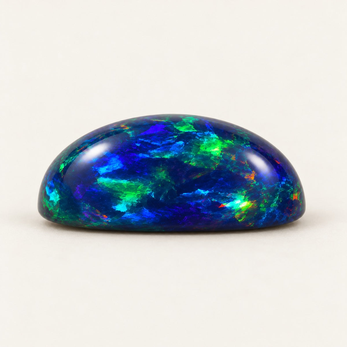 Black lab-grown opal, oval cabochon, side view