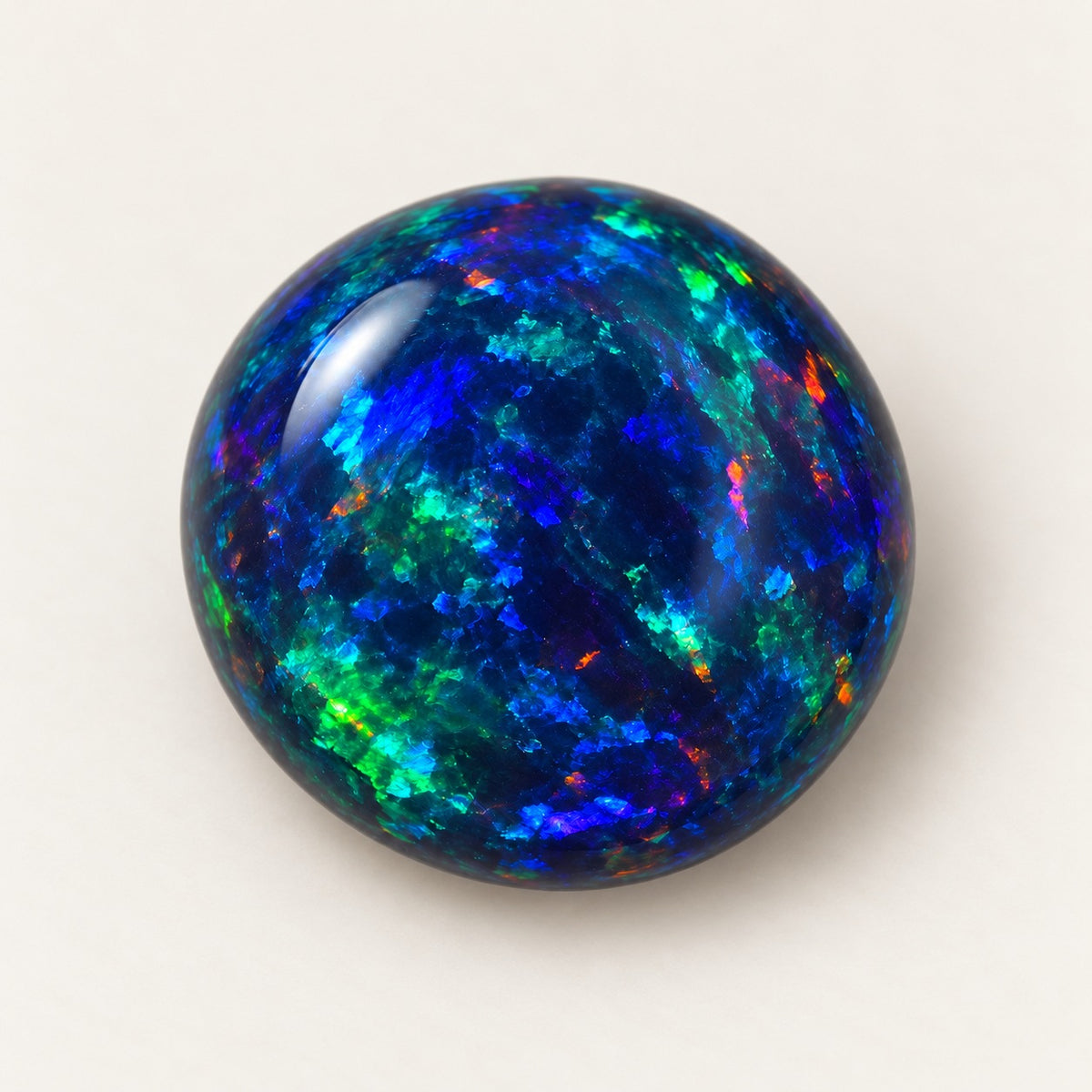 Black lab-grown opal, round cabochon, 45° view