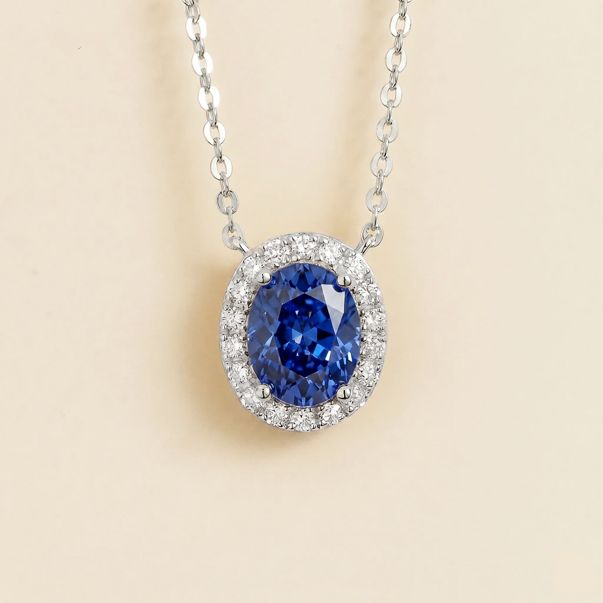 Lab-grown blue sapphire and diamond oval halo necklace in white gold – front view | Mina by Juvetti