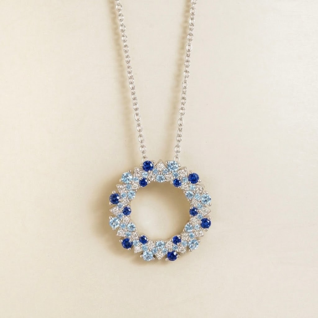 Starry blue sapphire and diamond eternity circle pendant necklace in white gold, front view