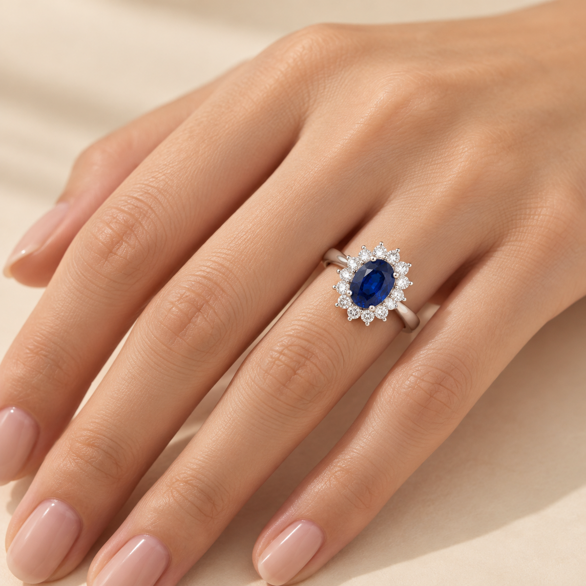 Oval blue sapphire and diamond halo ring in white gold worn on hand | Divo by Juvetti