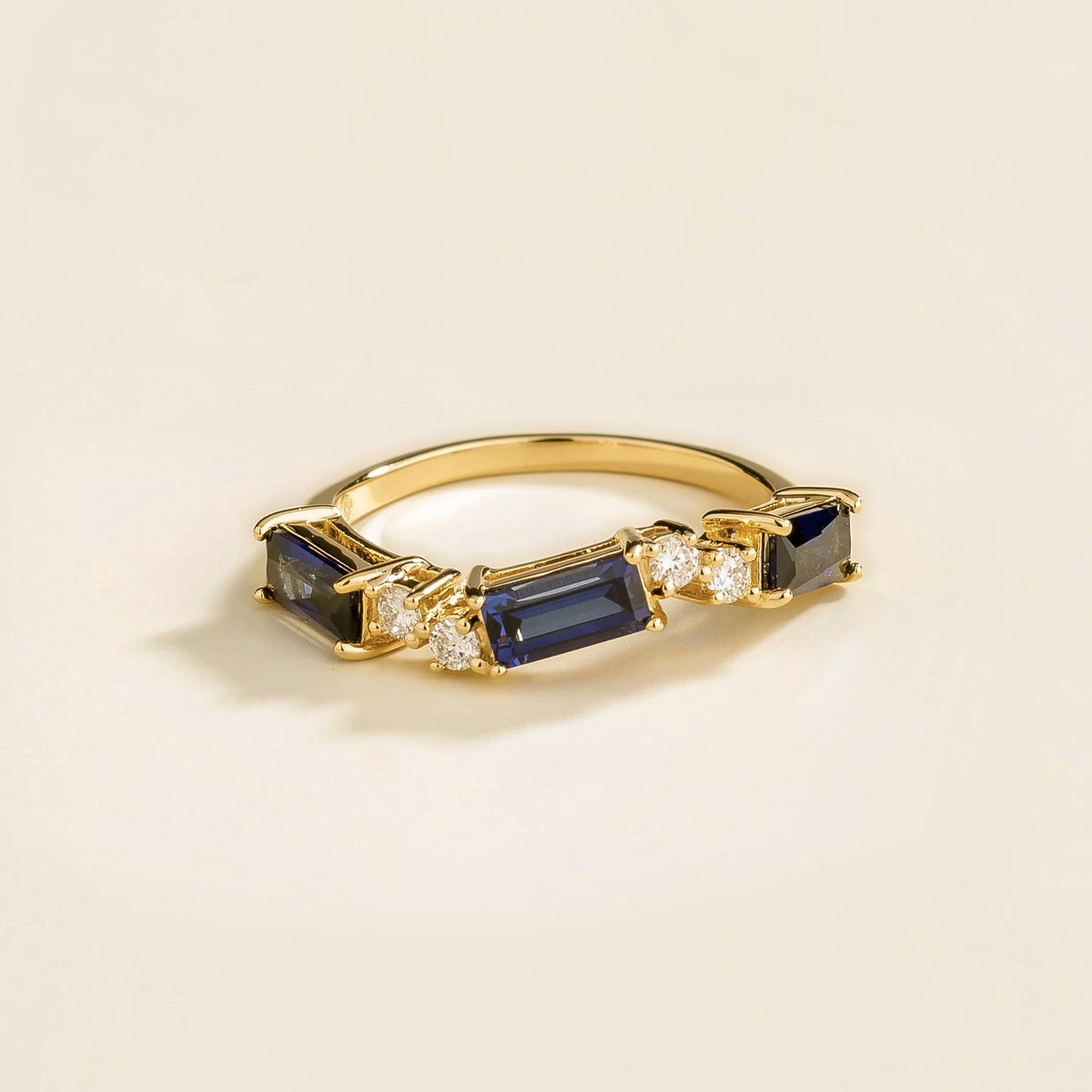 Juvetti gold ring showcasing ethical lab-grown baguette-cut royal blue sapphires and round brilliant diamonds.