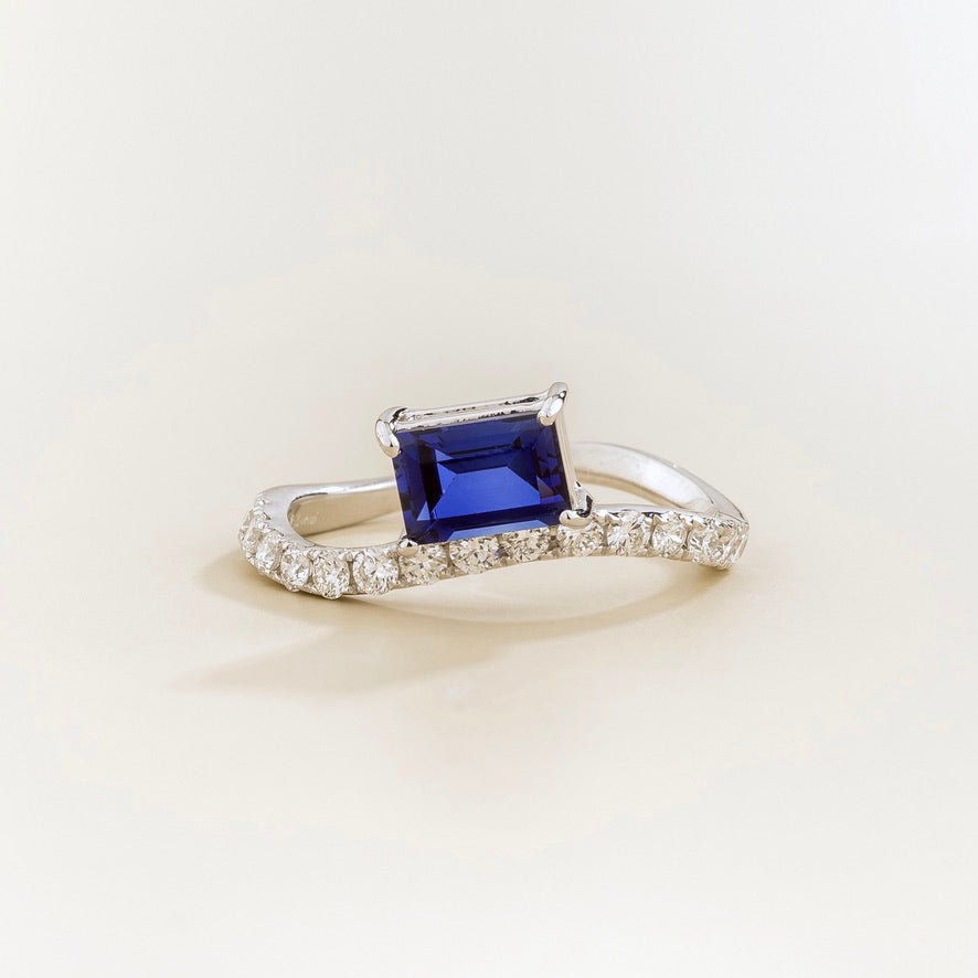 Luno blue sapphire emerald-cut ring with diamond pavé in white gold, lab-grown sapphire set east-west, front view | Juvetti London