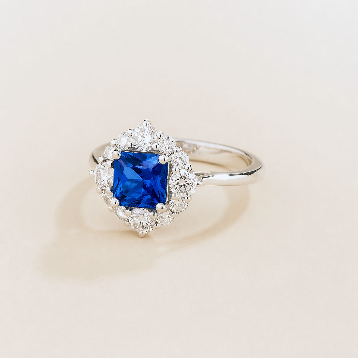 Tuli cushion-cut lab-grown blue sapphire and diamond halo ring in white gold – angle view | Juvetti London