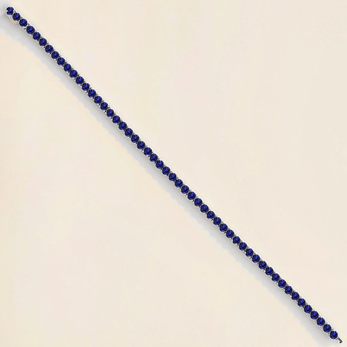 Round blue sapphire tennis bracelet set in white gold