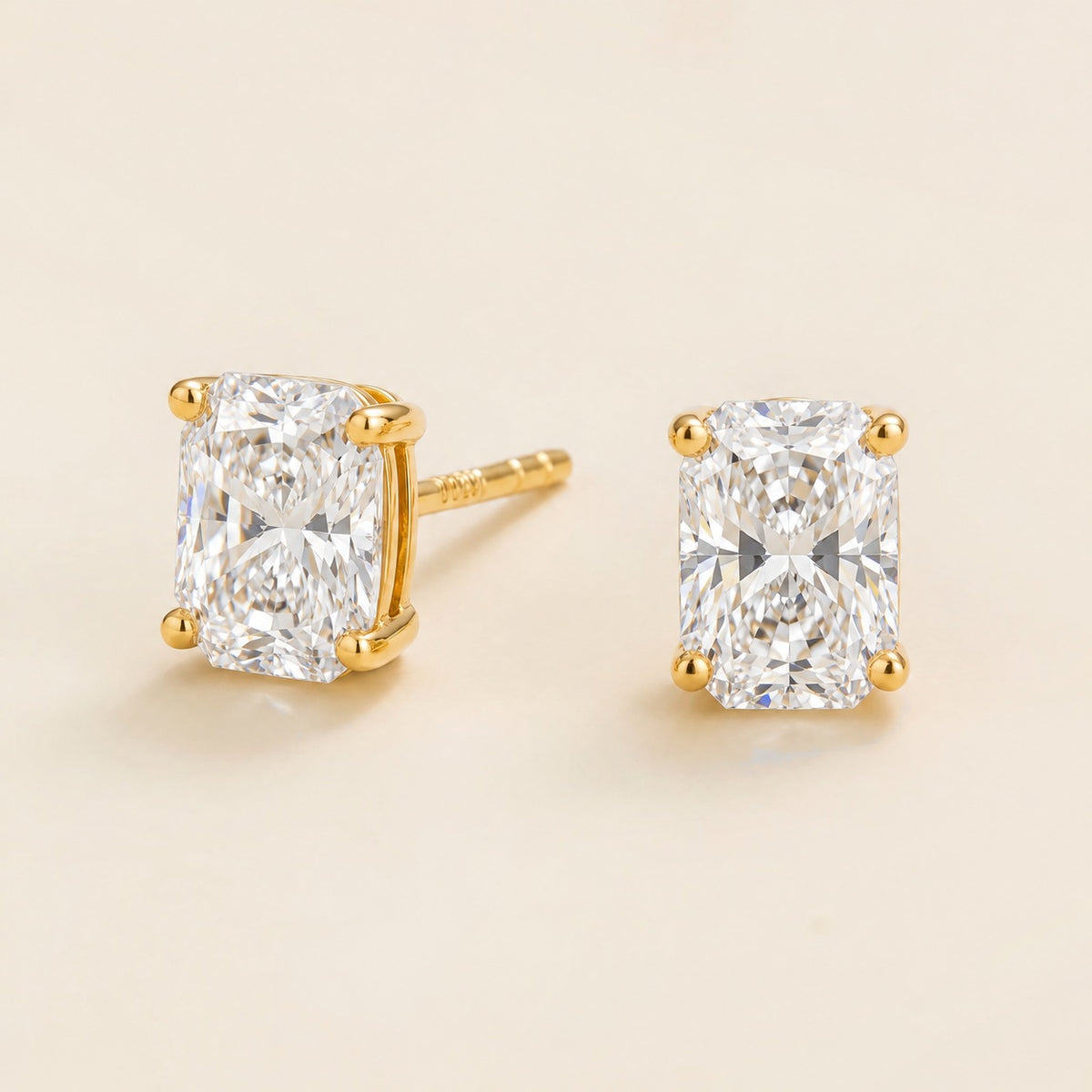 Clair radiant lab-grown diamond solitaire stud earrings in gold – angled view | Juvetti