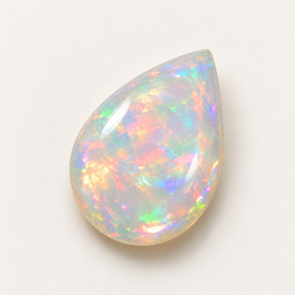 Crystal lab-grown opal, pear cabochon, 45° view