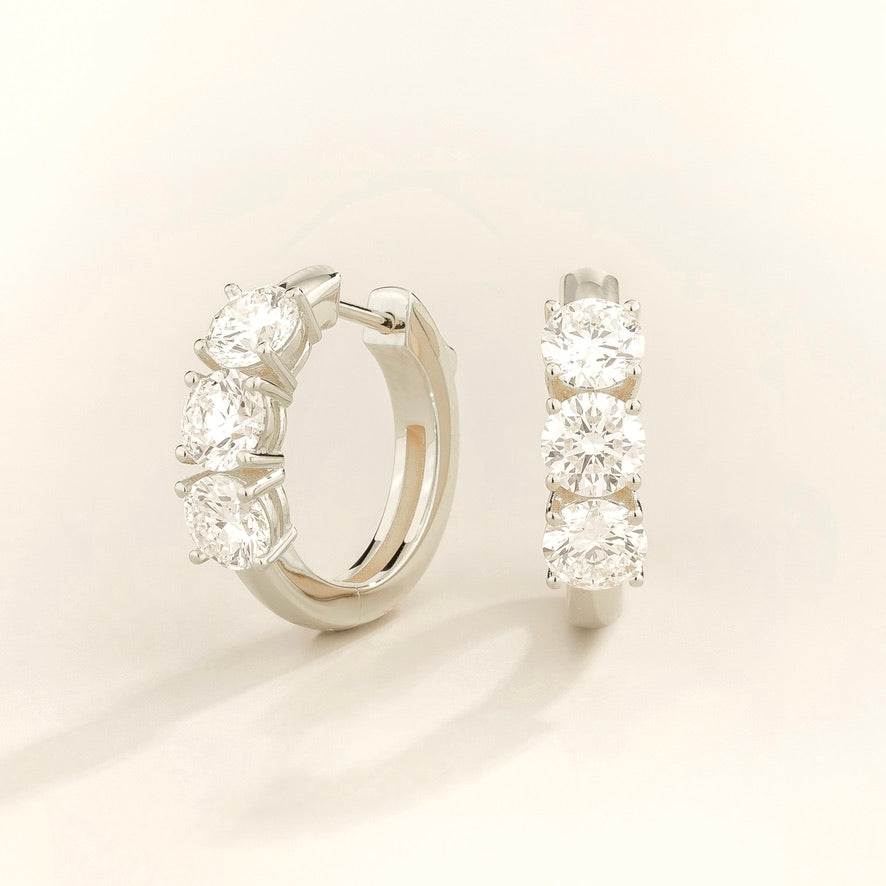 Tres diamond three-stone huggie hoop earrings in white gold