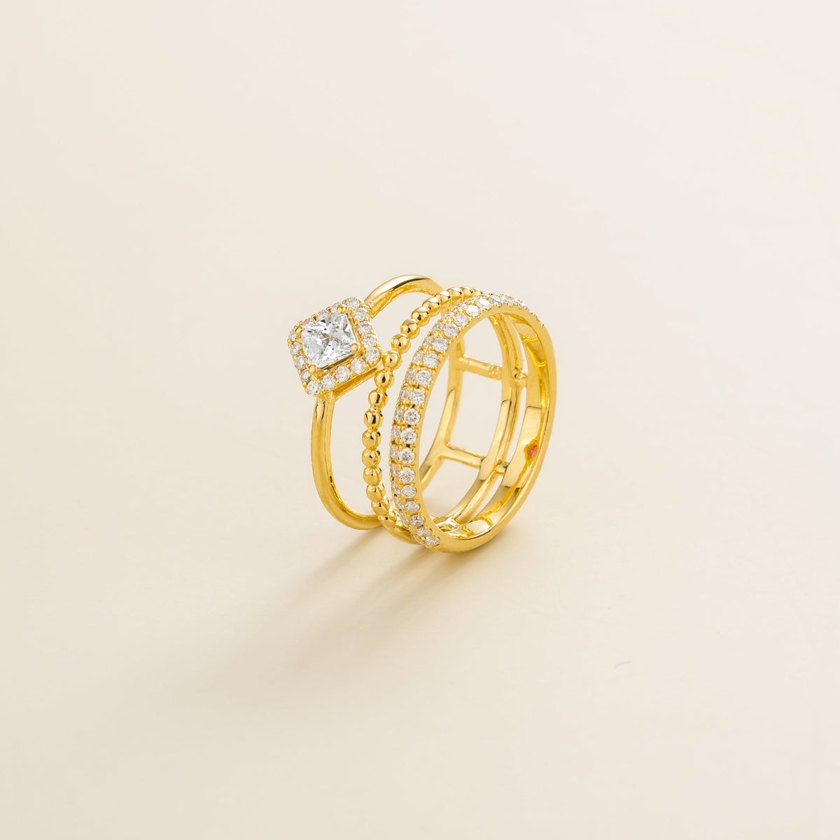 Amici triple-band stacking ring in gold, princess-cut lab-grown diamond in a diamond halo with beaded and pavé bands, side view | Juvetti London