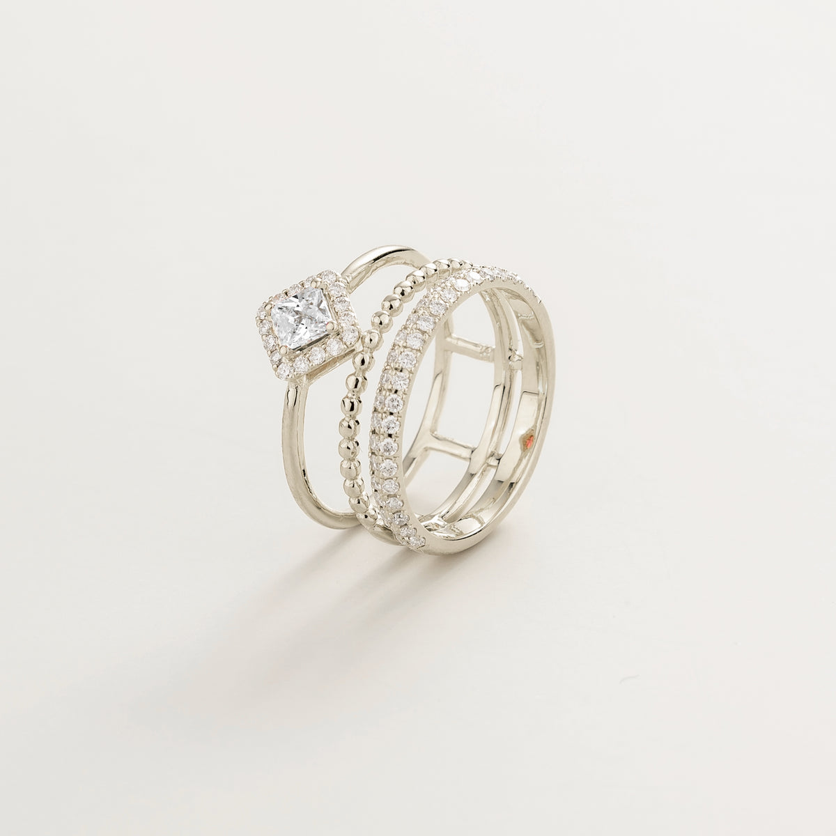 Amici triple-band stacking ring in white gold, princess-cut lab-grown diamond in a diamond halo with beaded and pavé bands, side view | Juvetti London