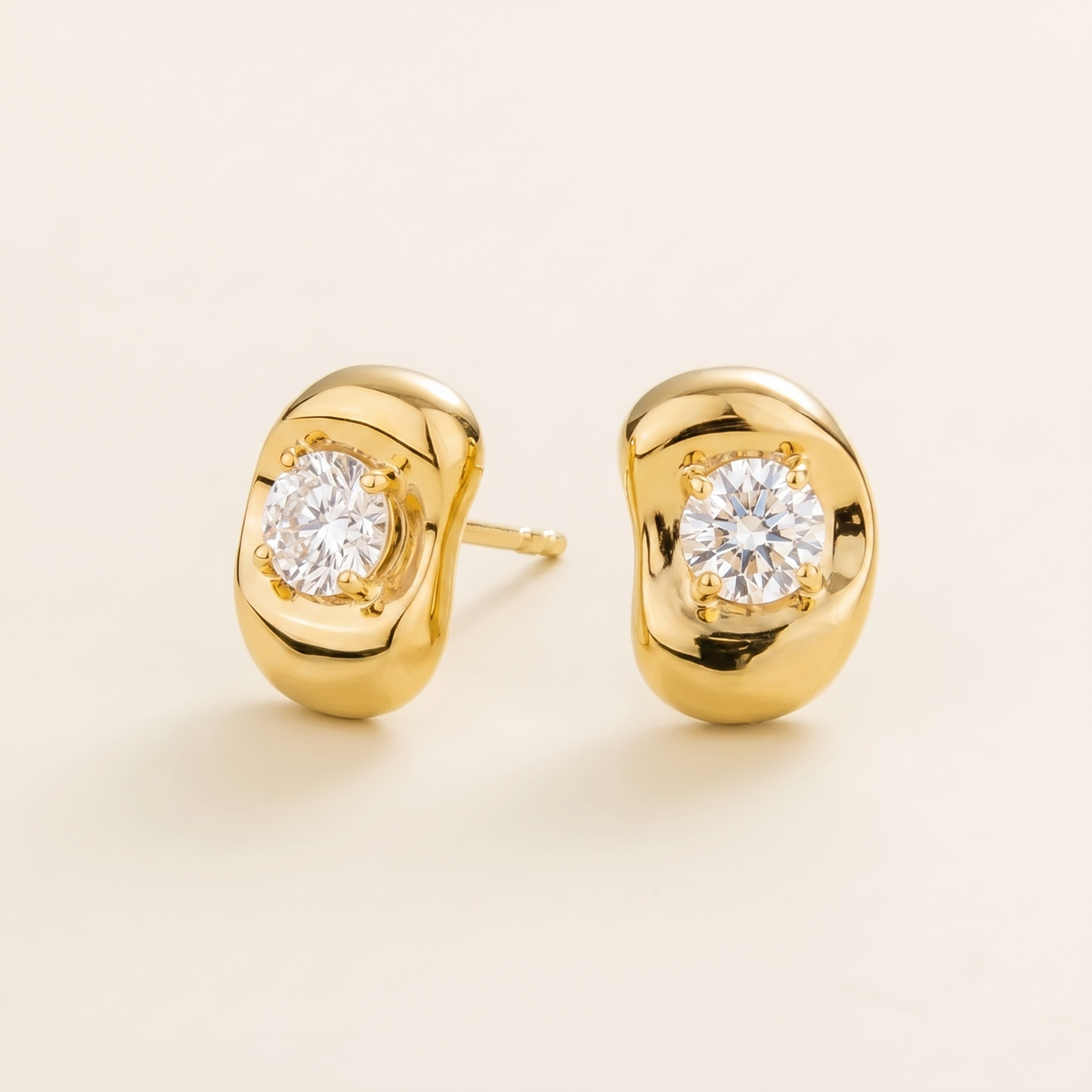 Fava round lab-grown diamond stud earrings in gold, sculpted pebble setting, angled view | Juvetti London