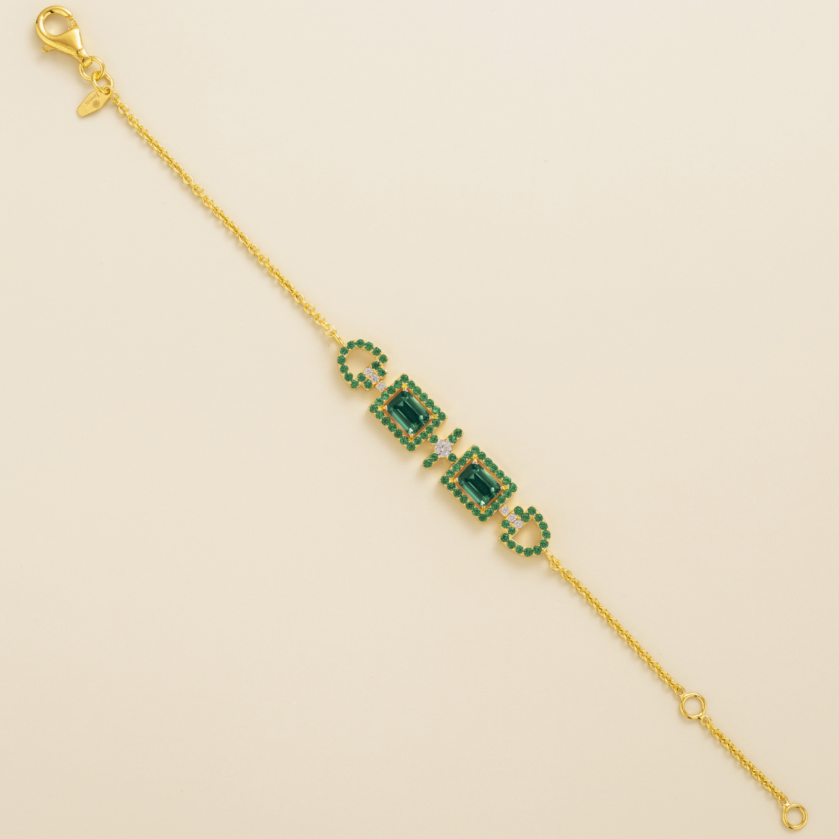 Ciceris emerald Art Deco halo bracelet in gold, two emerald-cut lab-grown emeralds with diamonds, full length | Juvetti London