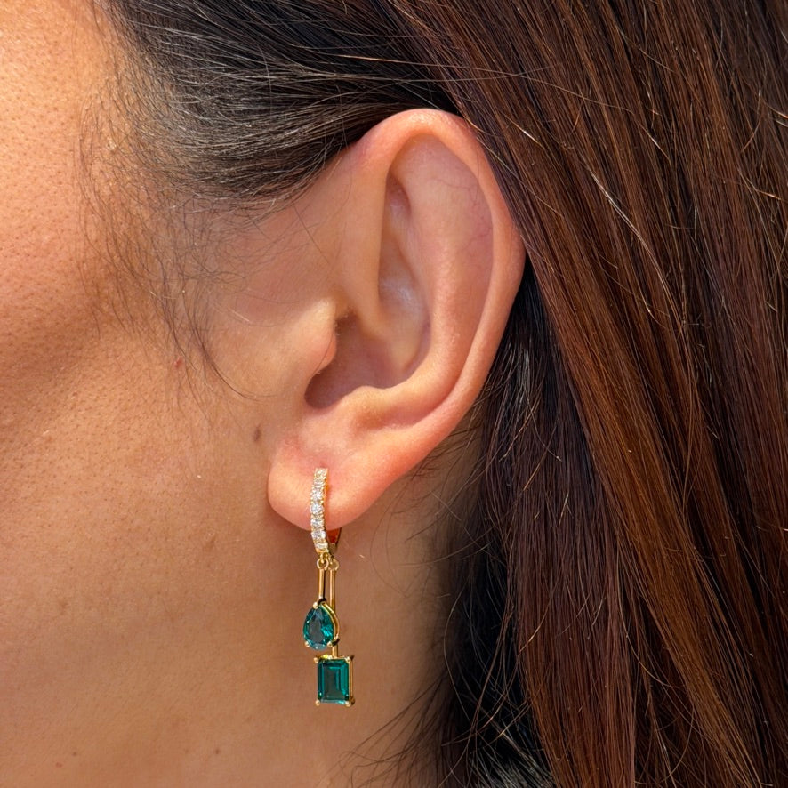 Faire emerald huggie drop earrings in gold, pear and baguette-cut lab-grown emeralds with diamond pavé, worn on the ear | Juvetti London