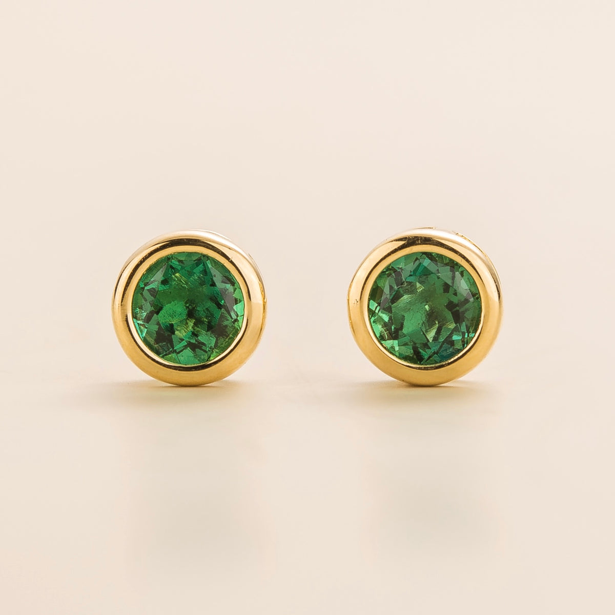 Margo emerald round bezel set solitaire stud earrings in gold