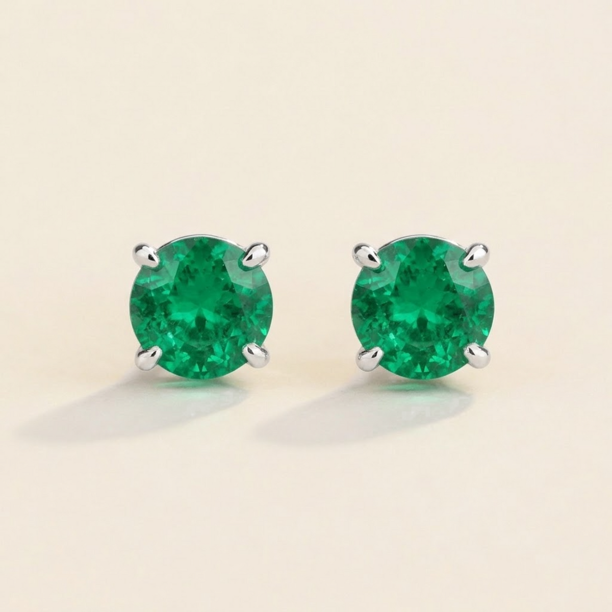 Nina round lab-grown emerald solitaire stud earrings in white gold – front view | Juvetti London