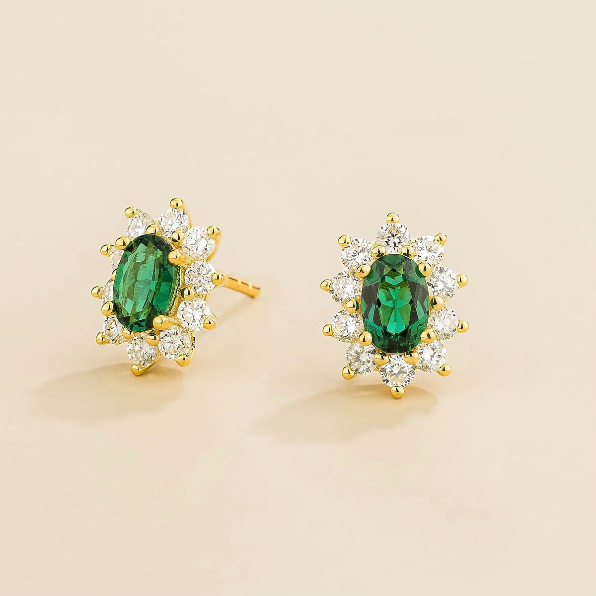 Oda Oval Emerald & Diamond Halo Earrings in Gold – angle view