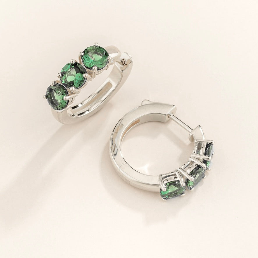 Tres Emerald Three-Stone Huggie Hoops in White Gold – angle view