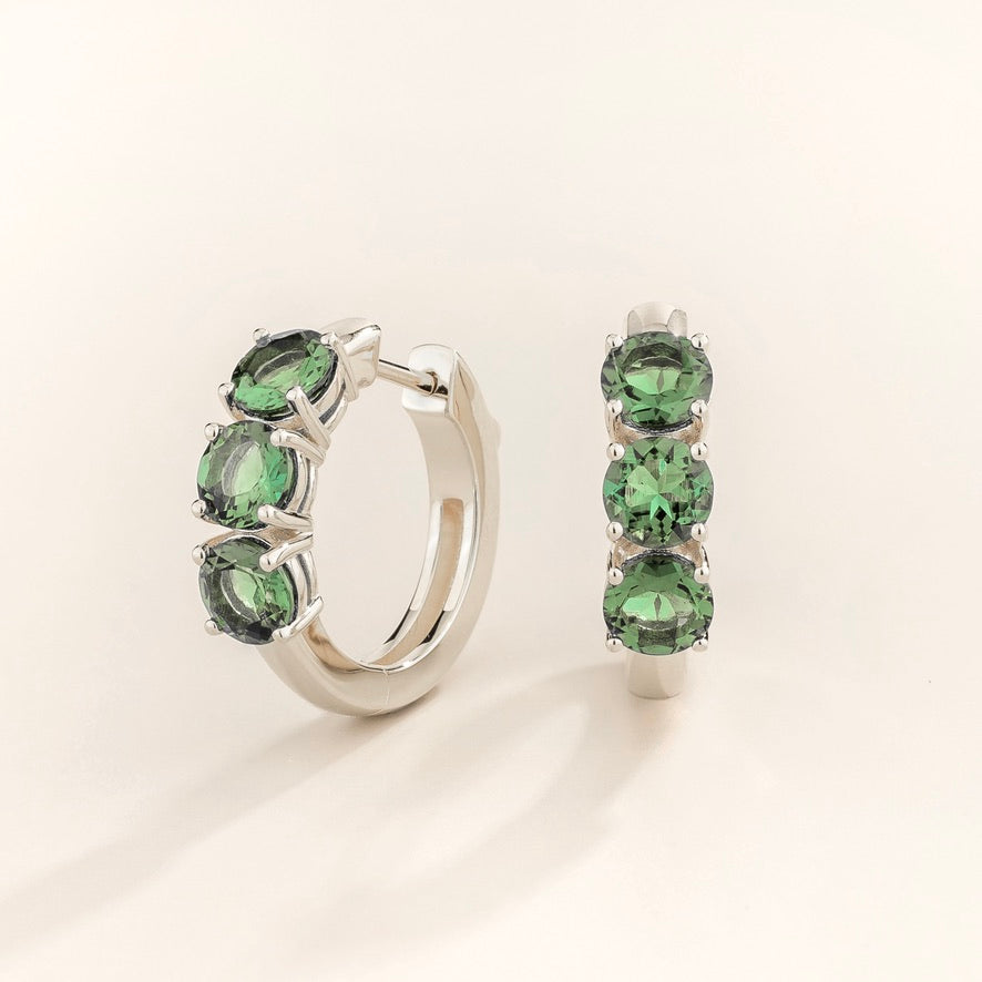 Tres emerald three-stone huggie hoop earrings in white gold