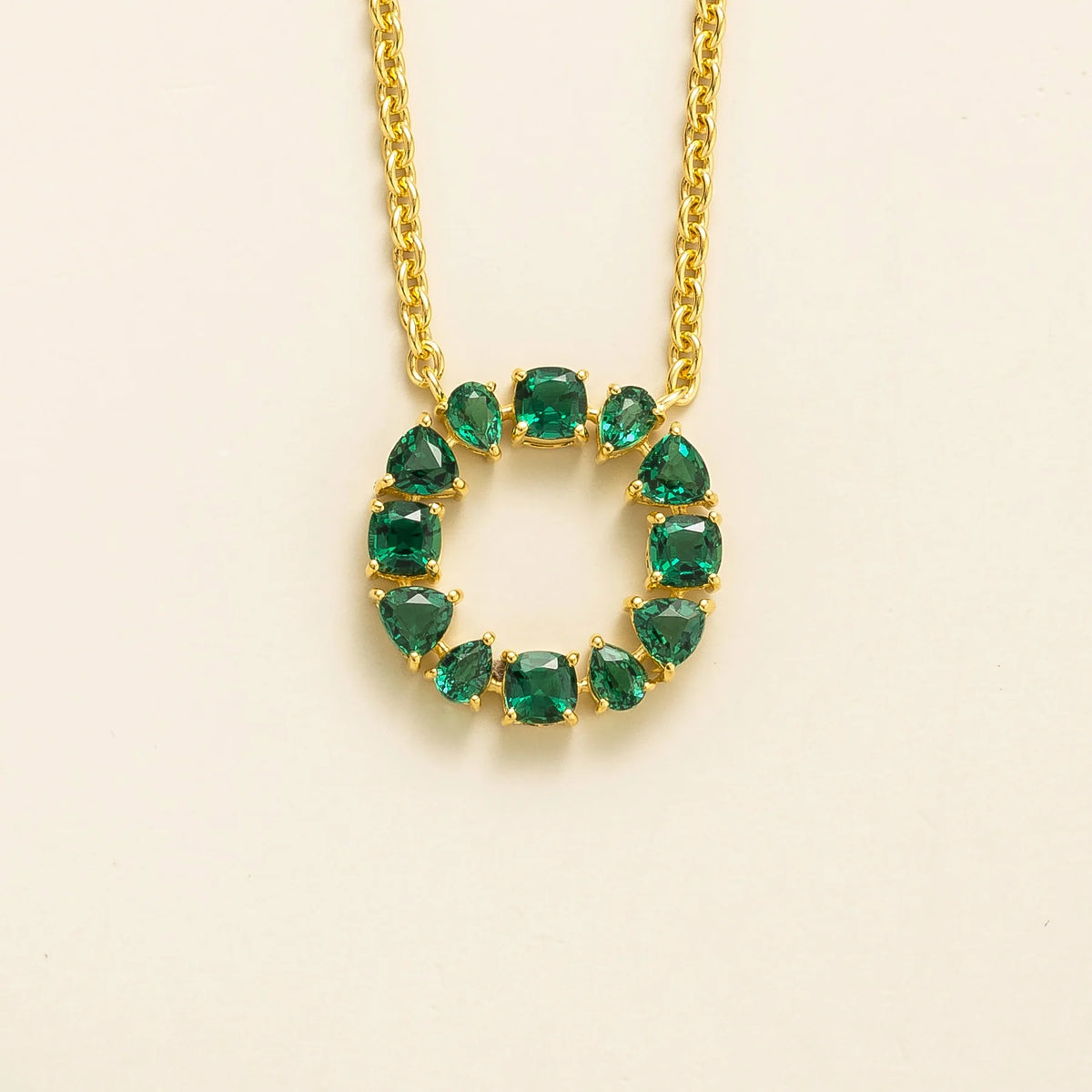 Glorie emerald open circle pendant necklace in gold, mixed-cut lab-grown emeralds, front view | Juvetti London
