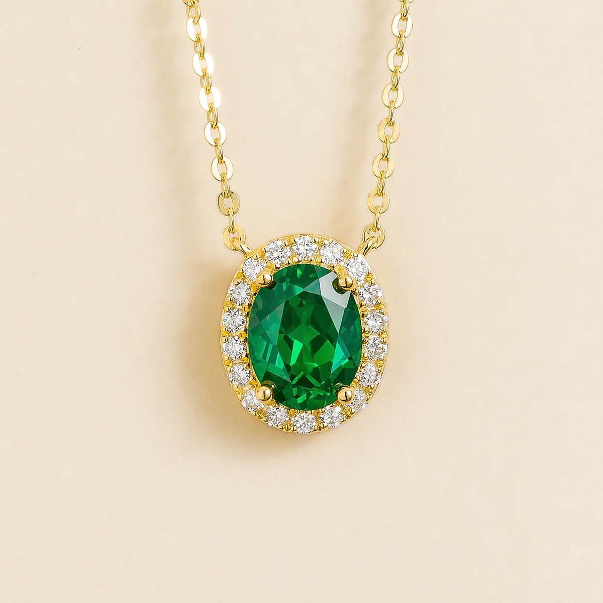 Lab-grown emerald and diamond oval halo necklace in gold – front view | Mina by Juvetti