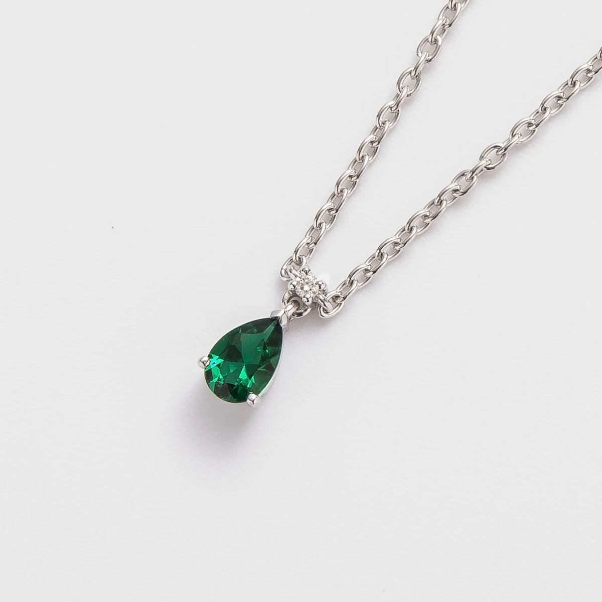Lab-grown emerald and diamond pear drop pendant necklace in white gold, small – angled view | Pisa by Juvetti
