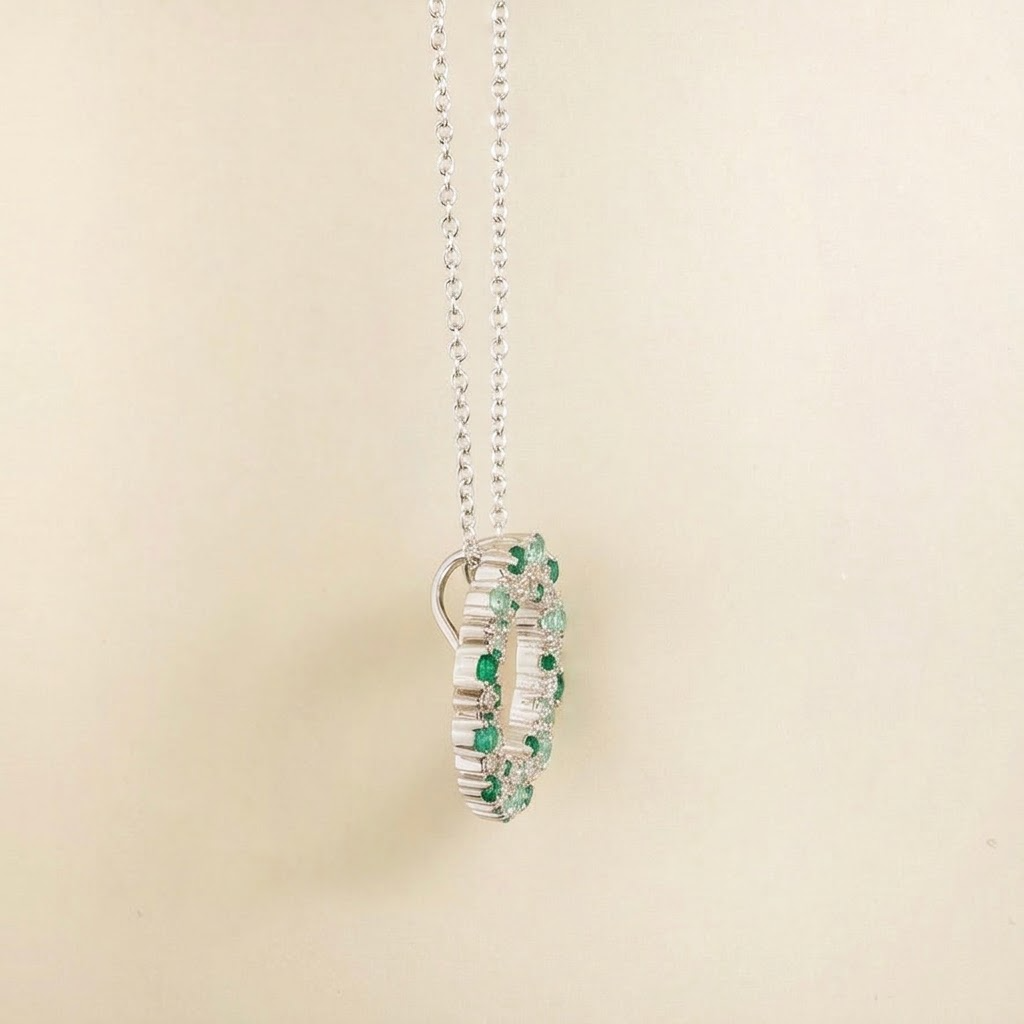 Starry emerald, green sapphire and diamond eternity circle pendant necklace in white gold, side view