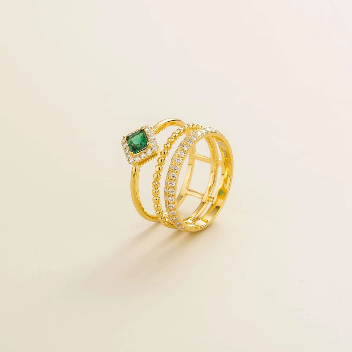 Amici triple-band stacking ring in gold, princess-cut lab-grown emerald in a diamond halo with beaded and pavé bands, side view | Juvetti London