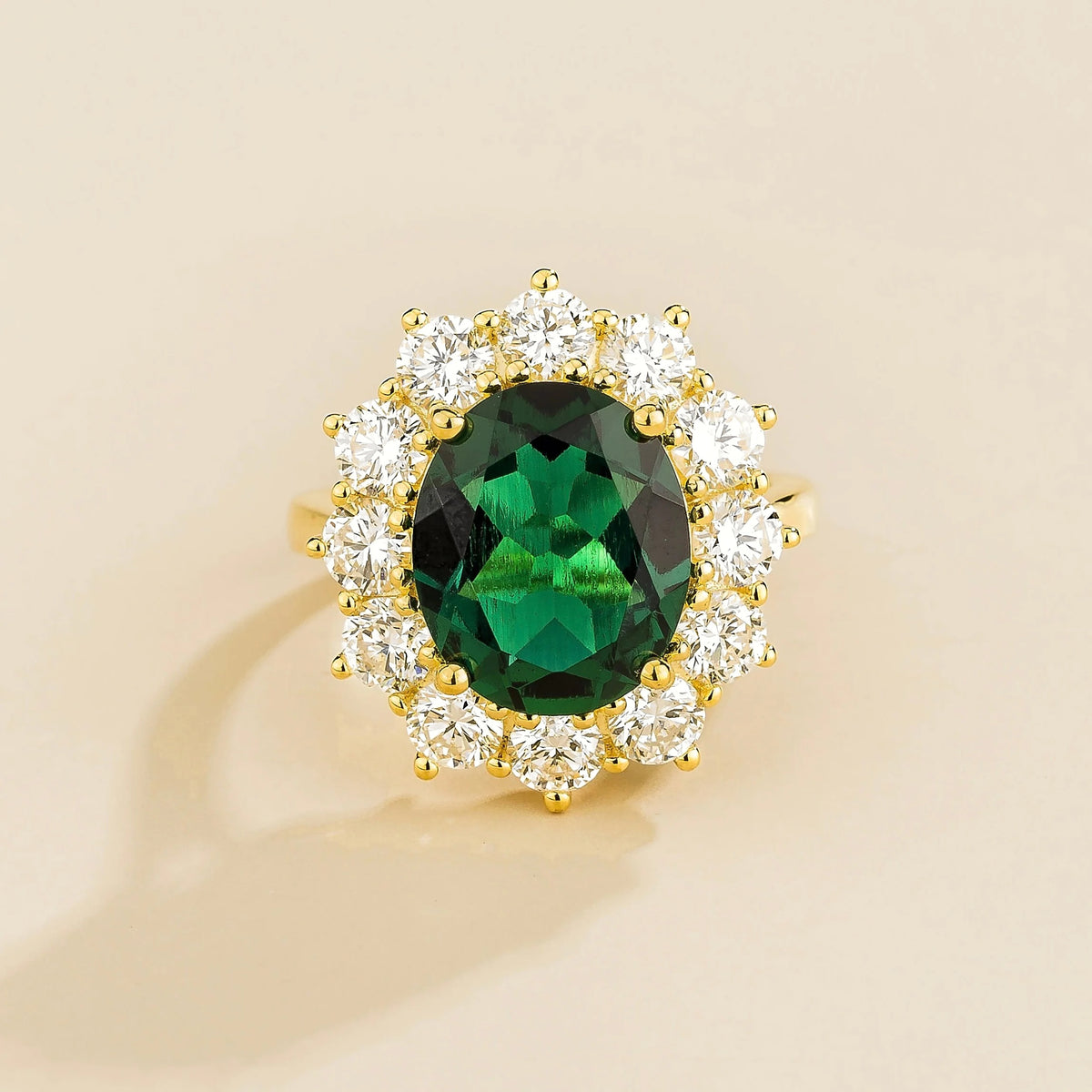 Oda oval emerald & diamond halo ring in gold