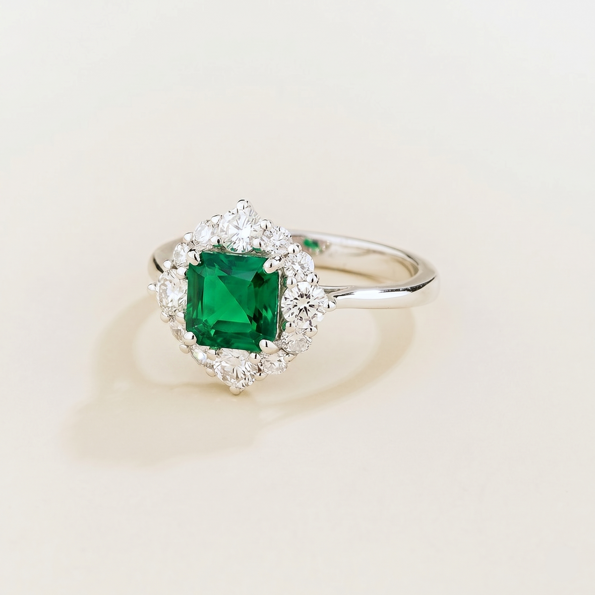 Tuli cushion-cut lab-grown emerald and diamond halo ring in white gold – angle view | Juvetti London