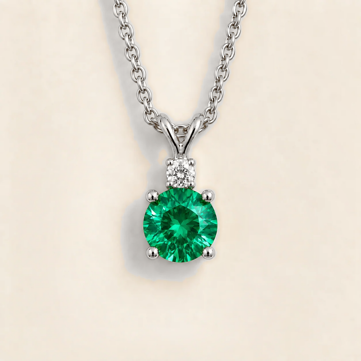 Round lab-grown emerald and diamond drop pendant necklace, Joie design in white gold | Juvetti London