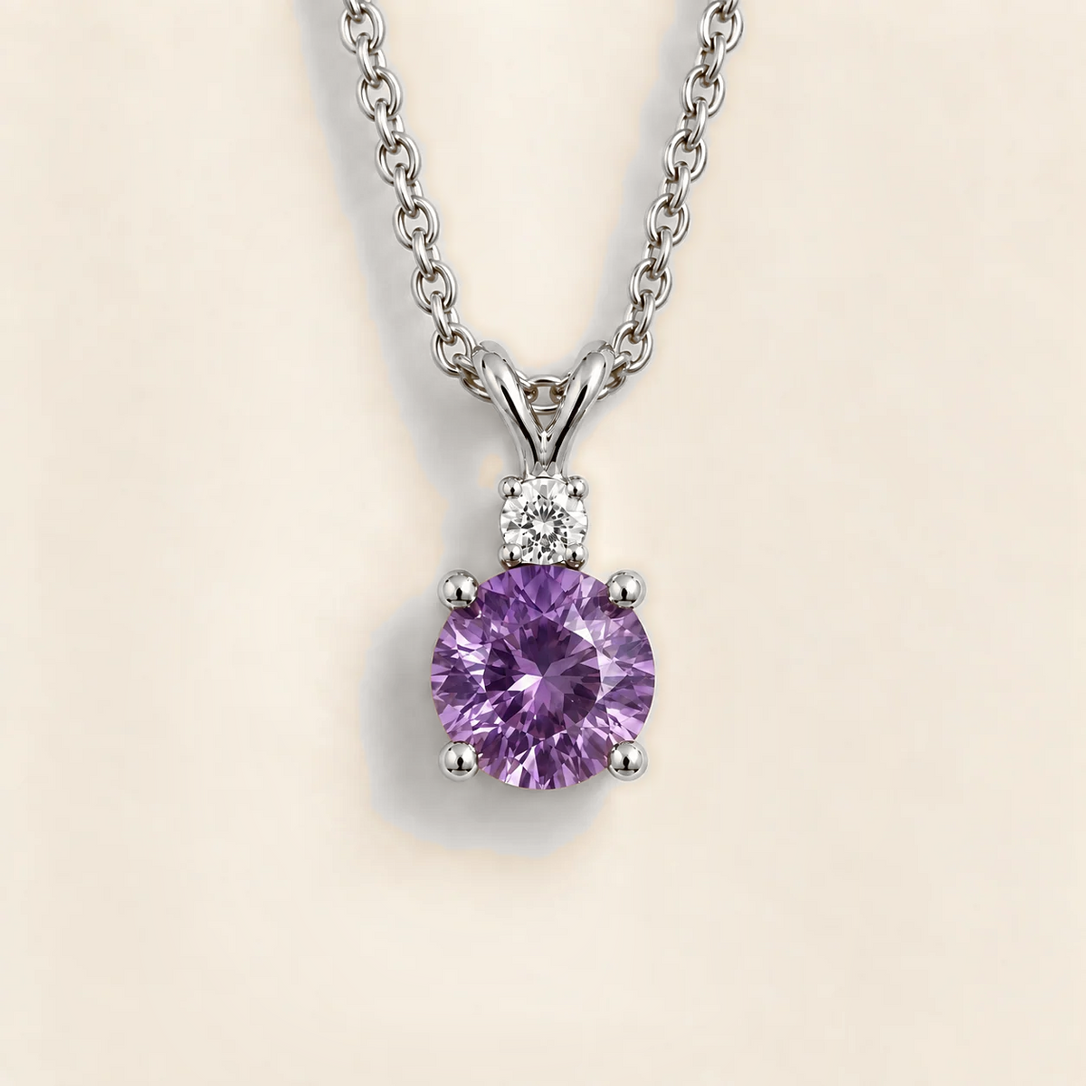 Front view of the Joie Round Purple Sapphire & Diamond Drop Pendant Necklace In White Gold, handcrafted by Juvetti London