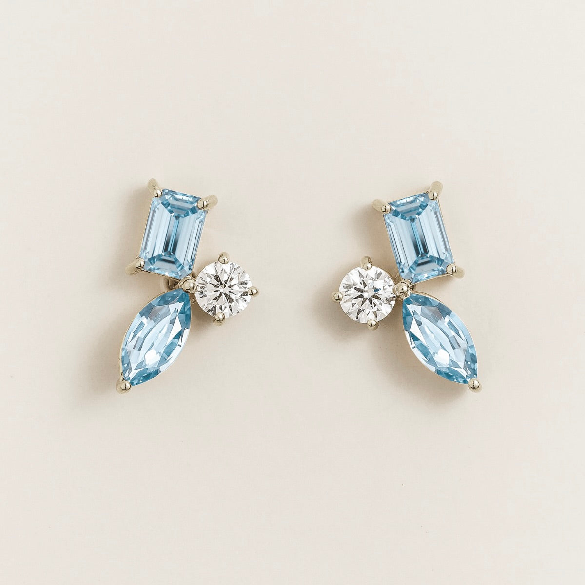 Sanka aquamarine cluster stud earrings in white gold: baguette and marquise lab-grown aquamarines, round diamond
