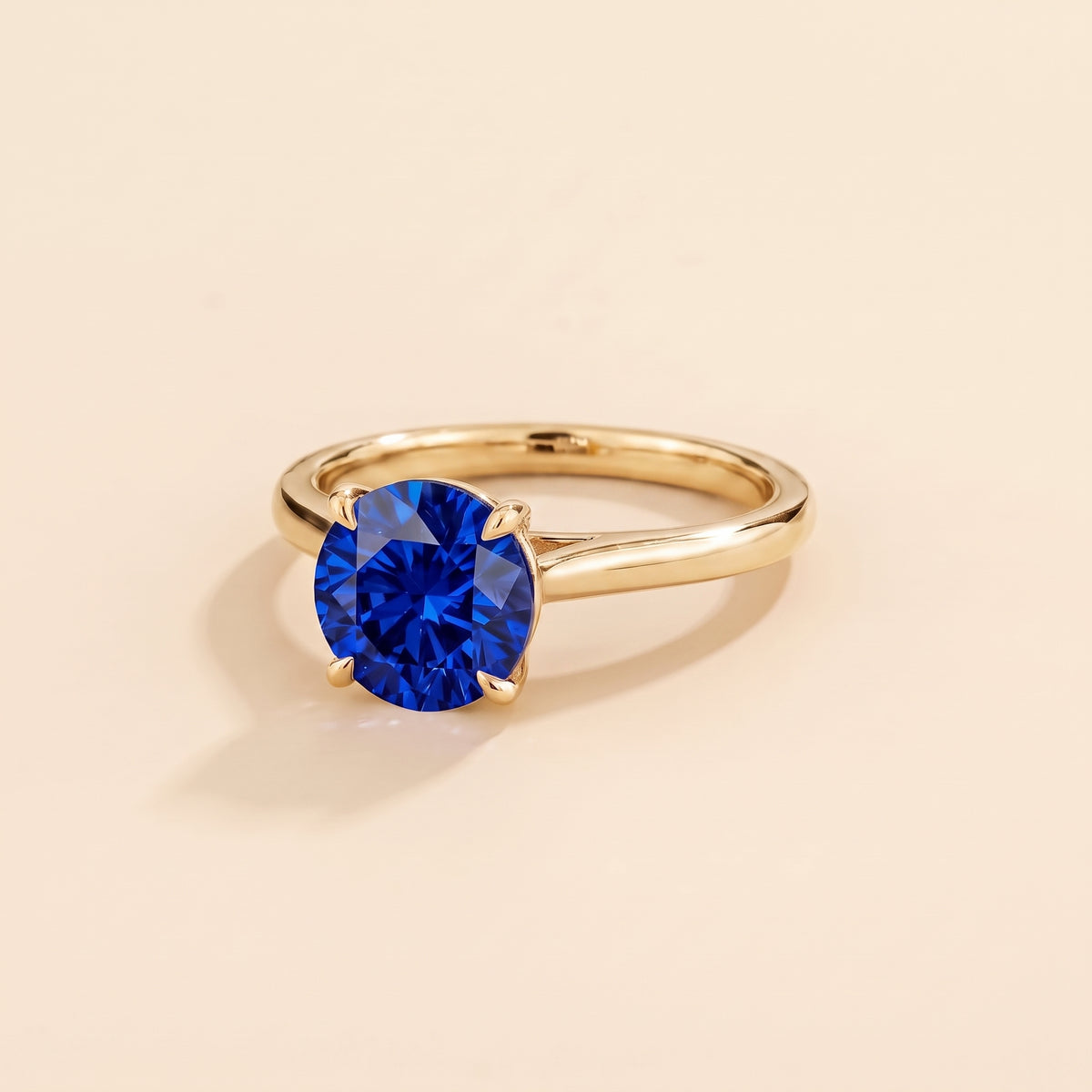 Nina Round Shape Blue Sapphire Cathedral Solitaire Ring in Gold, three-quarter view