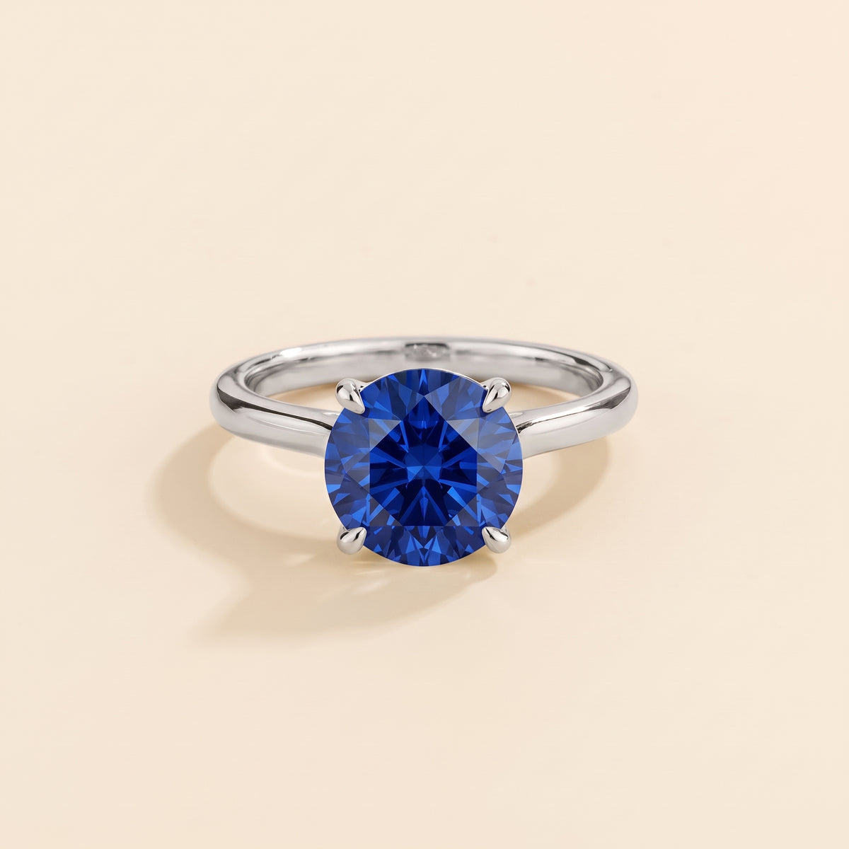 Nina Round Shape Blue Sapphire Cathedral Solitaire Ring in White Gold, front view