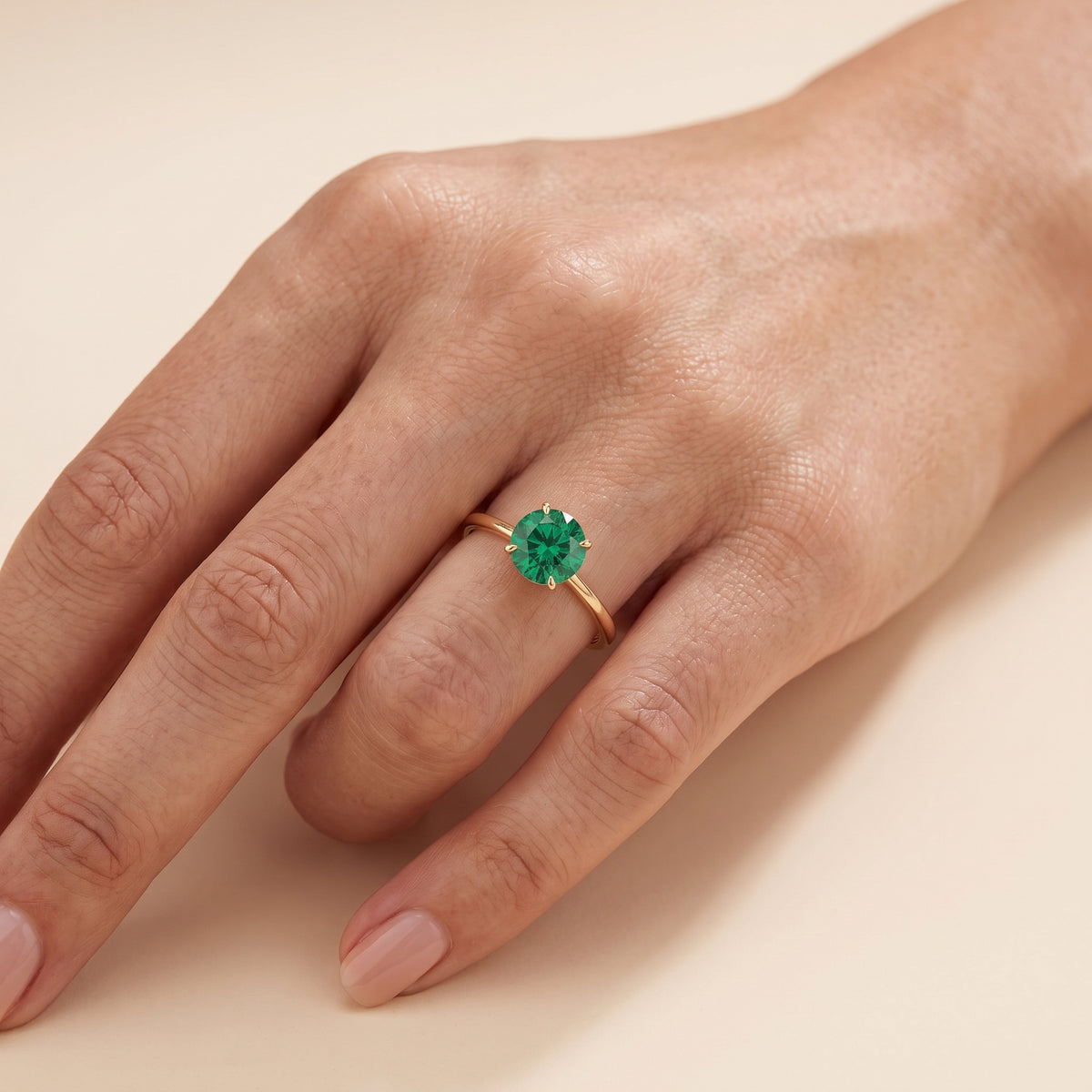 Model wearing the Nina Round Shape Emerald Cathedral Solitaire Ring in Gold