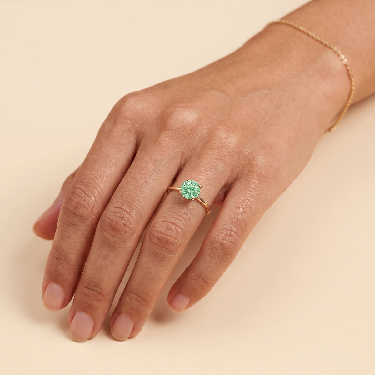 Model wearing the Nina Round Shape Green Sapphire Cathedral Solitaire Ring in Gold