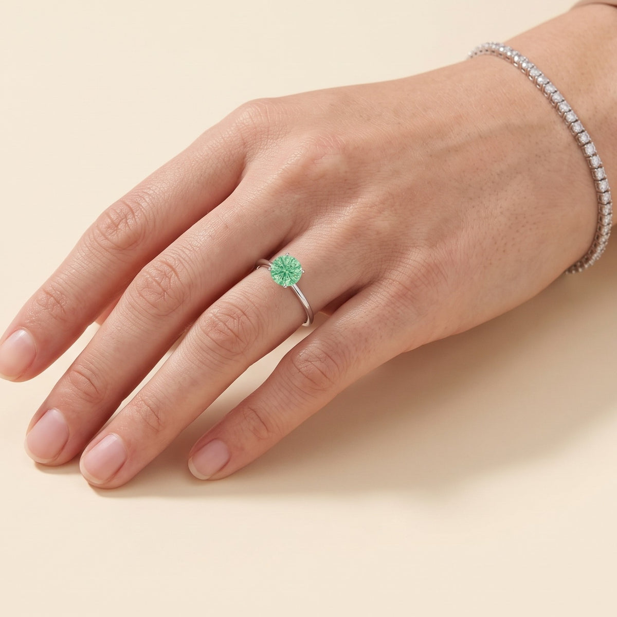 Model wearing the Nina Round Shape Green Sapphire Cathedral Solitaire Ring in White Gold