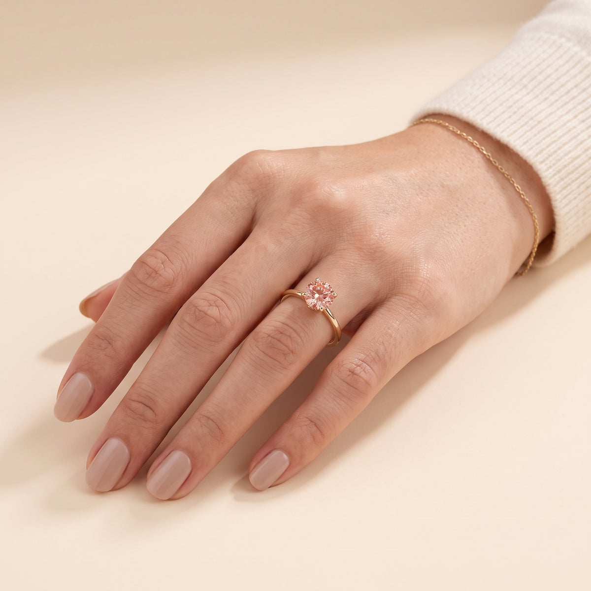 Model wearing the Nina Round Shape Padparadscha Sapphire Cathedral Solitaire Ring in Gold