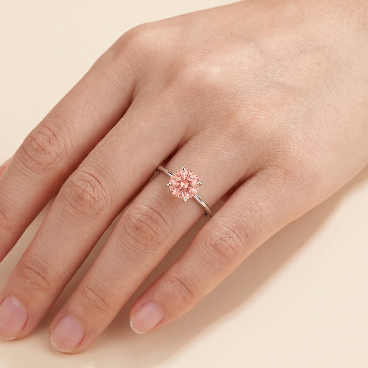 Model wearing the Nina Round Shape Padparadscha Sapphire Cathedral Solitaire Ring in White Gold
