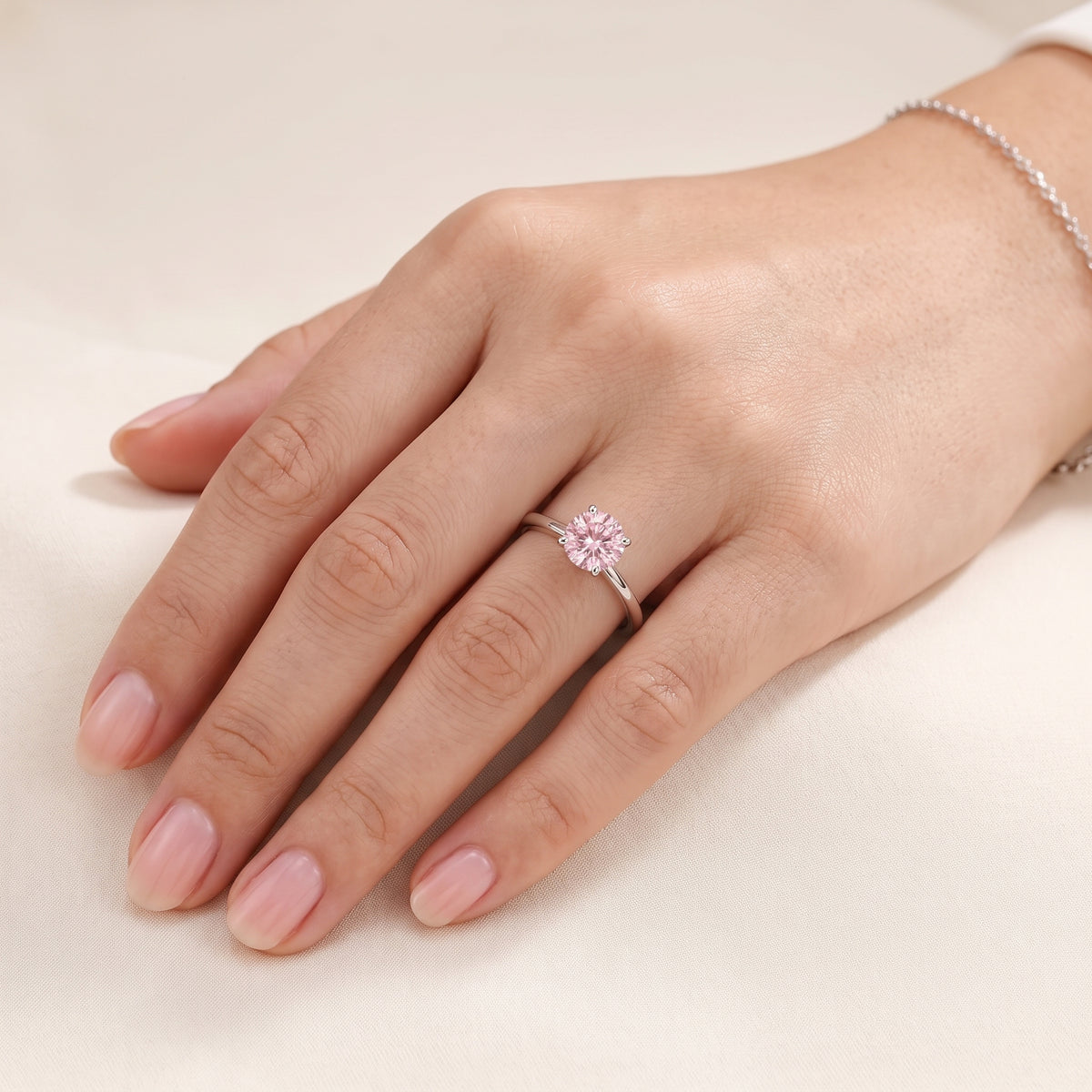 Model wearing the Nina Round Shape Pastel Pink Sapphire Cathedral Solitaire Ring in White Gold