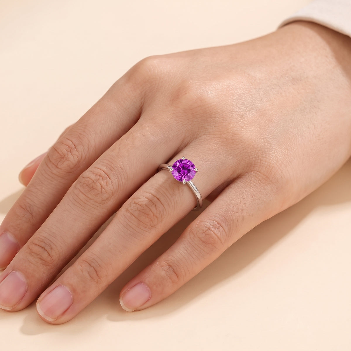Model wearing the Nina Round Shape Purple Sapphire Cathedral Solitaire Ring in White Gold