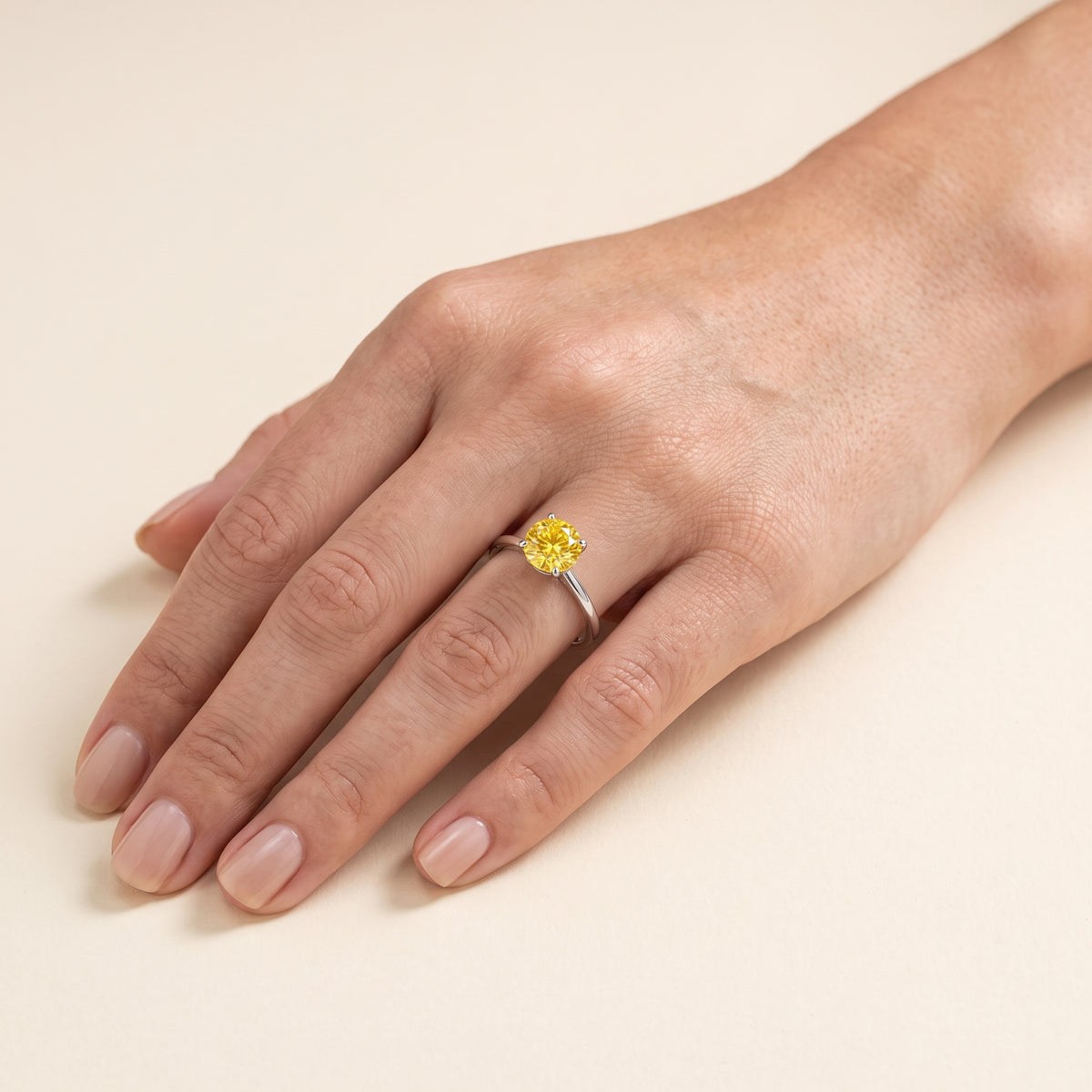 Model wearing the Nina Round Shape Yellow Sapphire Cathedral Solitaire Ring in White Gold