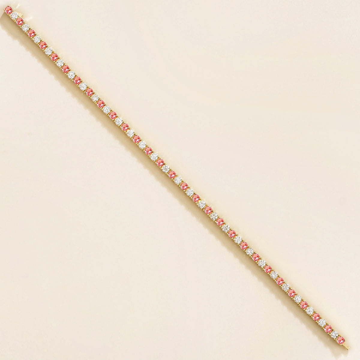 gold bracelet featuring round padparadscha sapphire gemstones and lab grown diamonds
