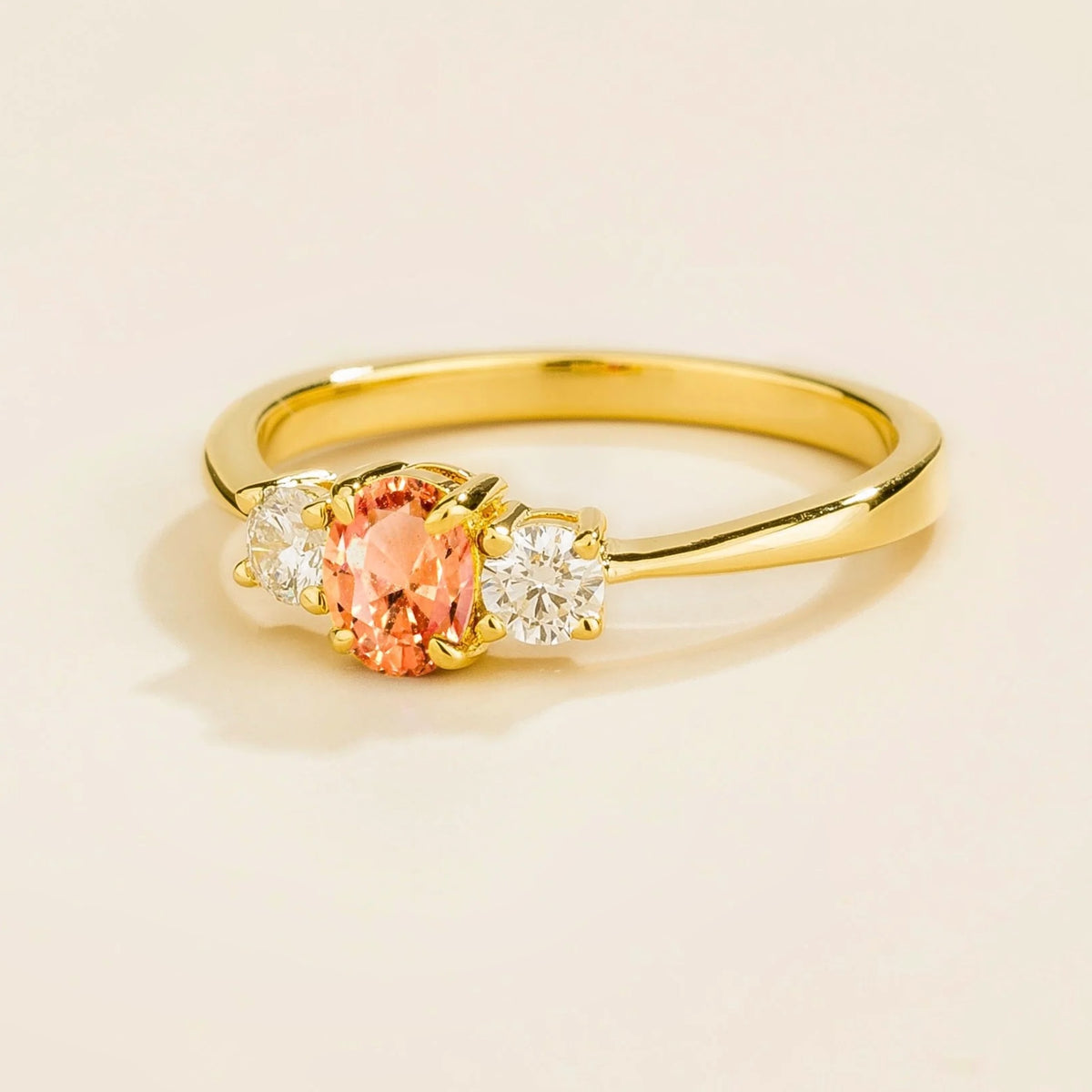 Boble Padparadscha Sapphire Oval & Diamond Three-Stone Ring in Gold – angle view