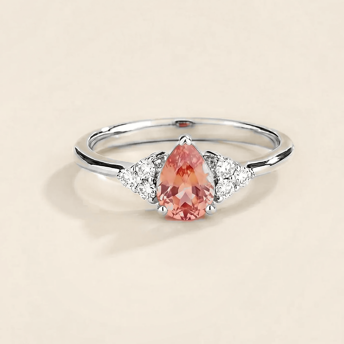 Pear-cut lab-grown padparadscha sapphire and diamond ring in white gold – front view | Pisa by Juvetti