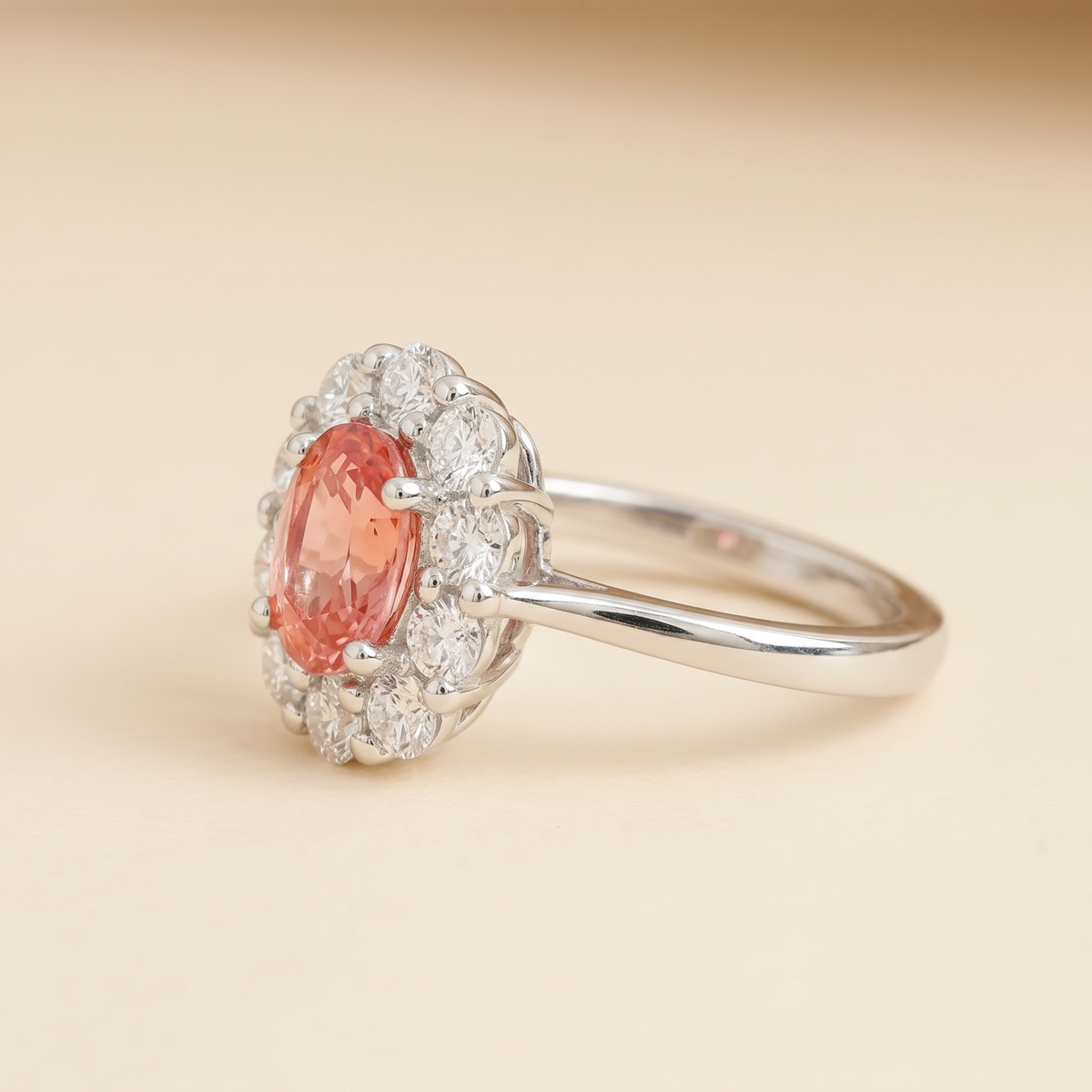Lab-grown padparadscha sapphire and diamond oval halo ring in white gold – side view | Prill by Juvetti