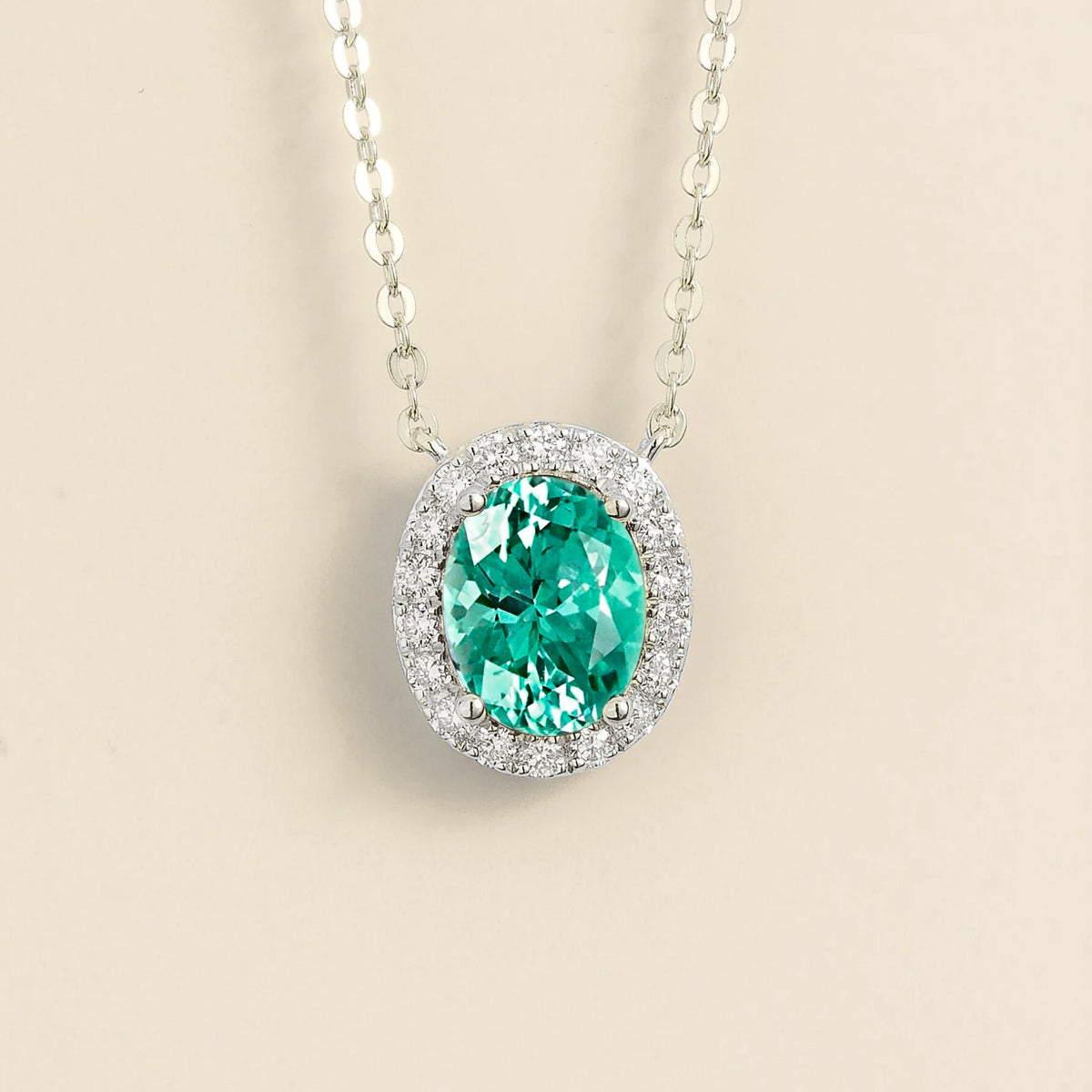Lab-grown Paraiba sapphire and diamond oval halo necklace in white gold – front view | Mina by Juvetti