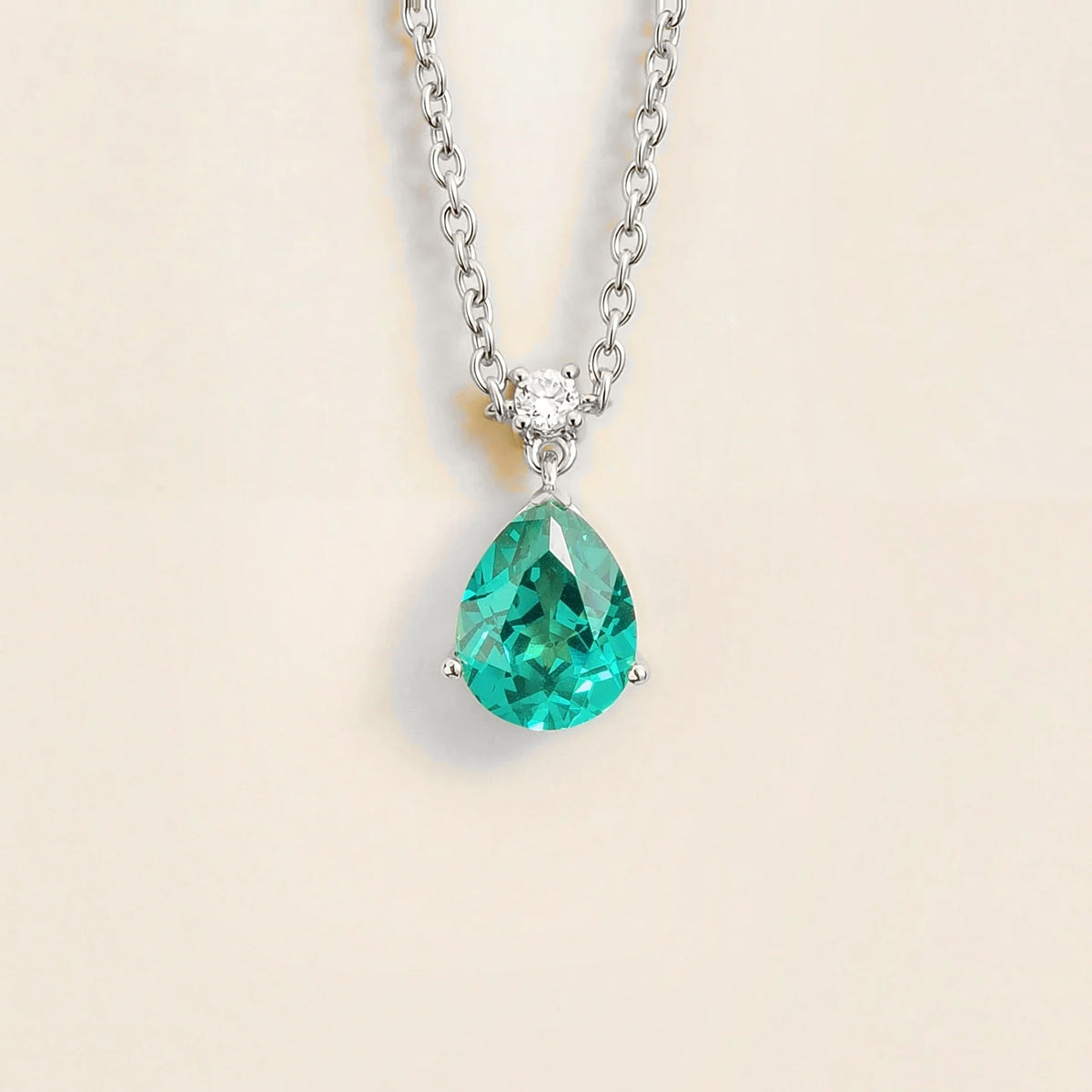 Lab-grown Paraiba sapphire and diamond pear drop pendant necklace in white gold, medium – front view | Pisa by Juvetti