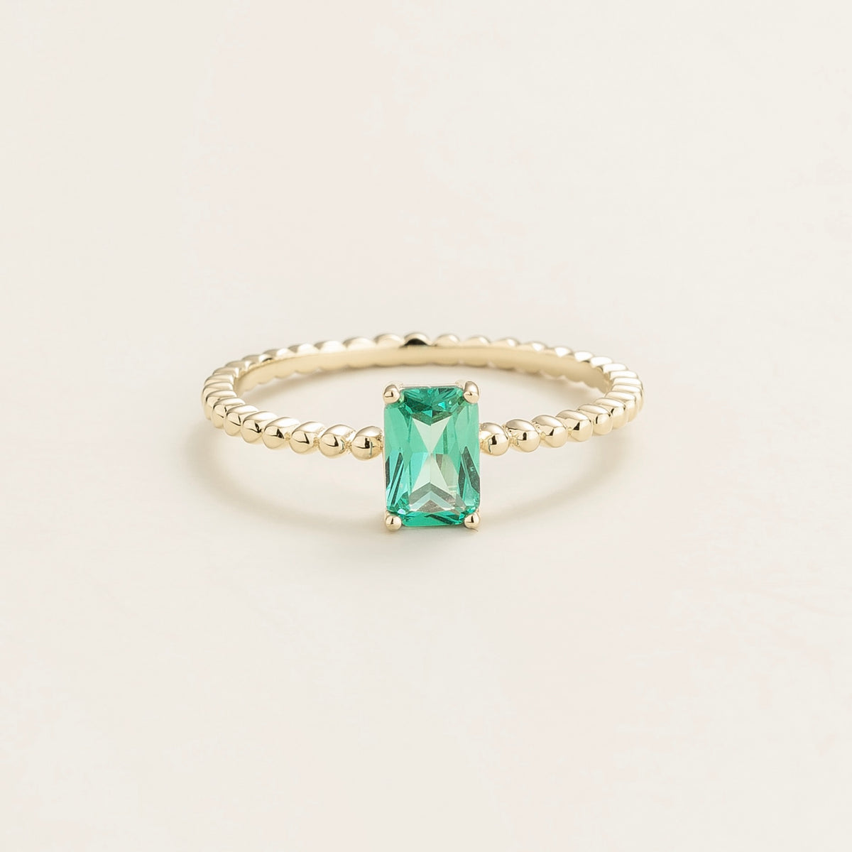 Fondi emerald-cut lab-grown Paraiba sapphire beaded band ring in gold – front view | Juvetti London